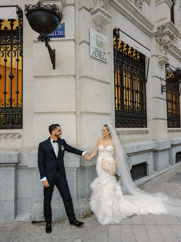 Couple's portraits in front of the Four Seasons Hotel, central Madrid, one of the best wedding venues in Spain. 