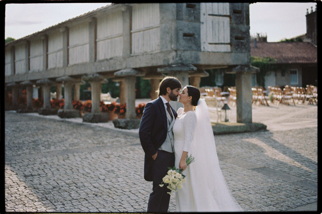 A kiss in from of the outside ceremony space, Pazo Señorans. one of the best wedding venues in Spain