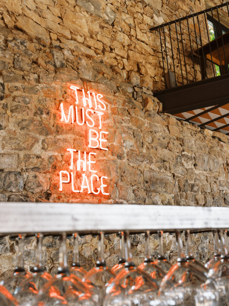 Neon sign above the bar at This Must be the place, one of the best wedding venues in Spain. 